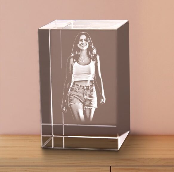 3D Tower crystal laser engraved with a woman portrait on an oak sideboard